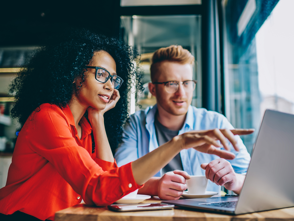 Woman and a man looking a computer screen